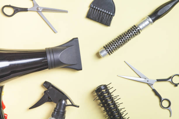 istock Scissors and other hair styling tools on yellow background. 1256049317