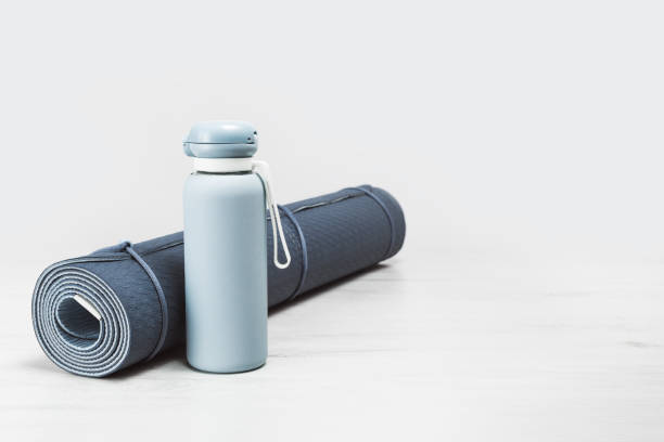 istock Rolled yoga mat and blue water bottle 1256049561