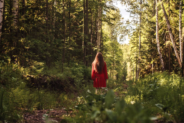 istock The young woman in forest. Back view. 1256052690
