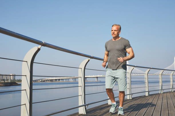 istock Jogging on embankment 1256056133