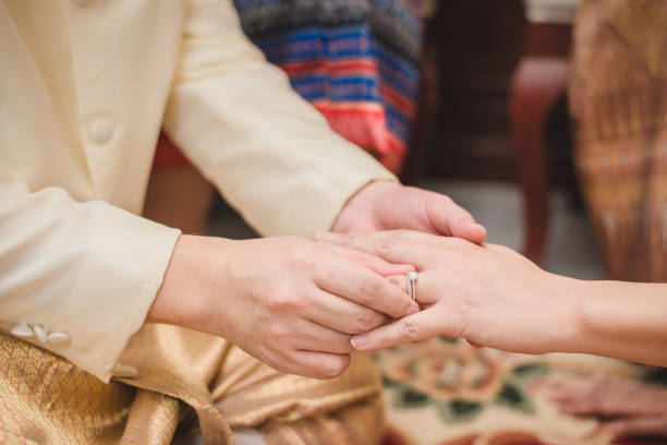 istock Wearing a wedding ring at a Thai wedding ceremony. 1256056400