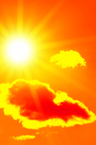 istock Bright sun with beautiful beams in the sky with clouds (toned in red) 1256059554