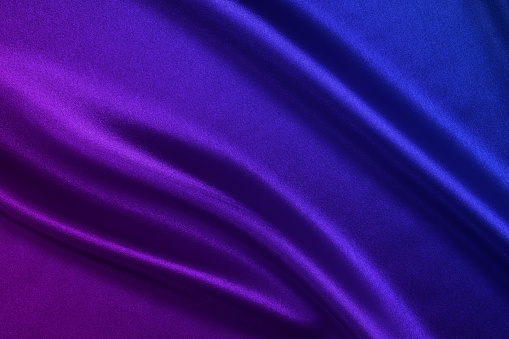 Wavy satin background in blue - purple colors.