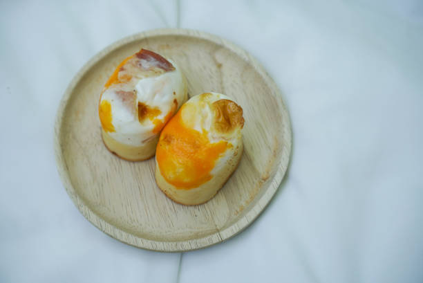 A Famous street food in Korea. Pancake flour baked with egg, topped with bacon.