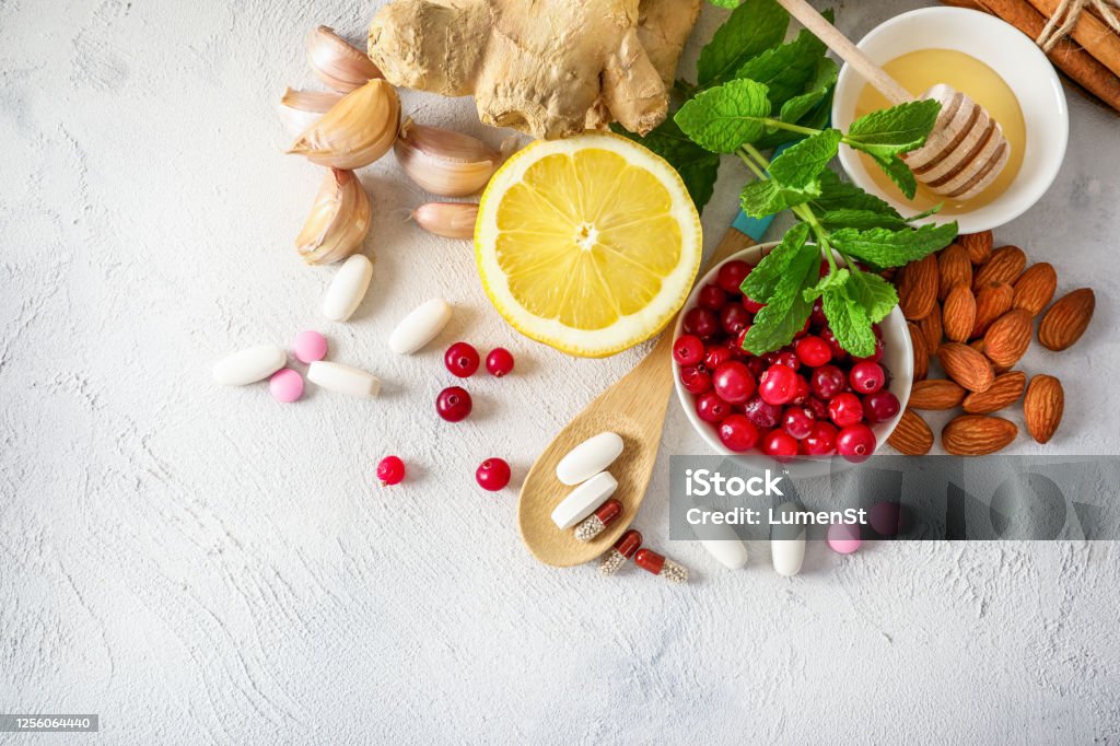 Drugs or natural products for immunity boosting Various healthy natural products for immunity boosting and cold remedies on white background. Top view. Nutritional Supplement Stock Photo