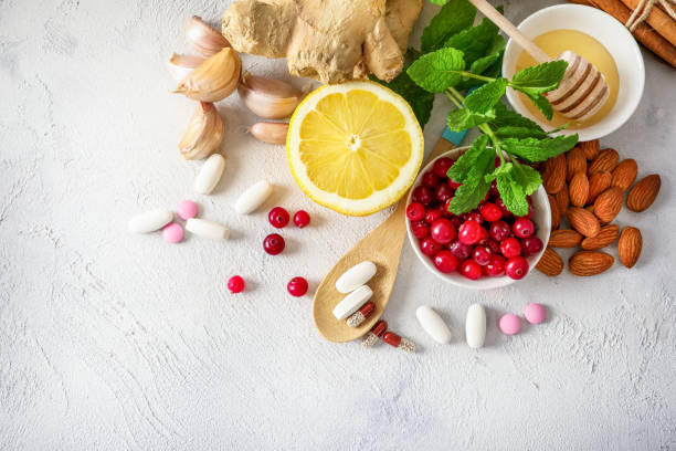 Drugs or natural products for immunity boosting Various healthy natural products for immunity boosting and cold remedies on white background. Top view. winter food top view stock pictures, royalty-free photos & images
