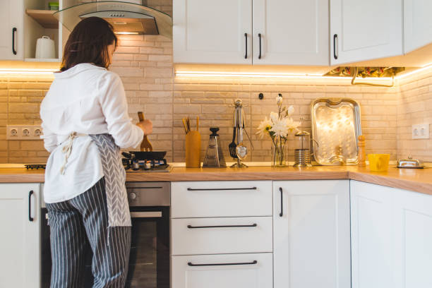istock view from behind woman on kitchen cooking 1256064673
