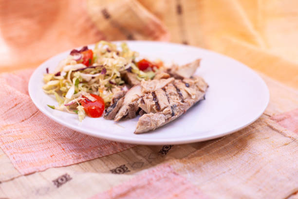 istock Grilled mackerel fillets with fresh salad and cherry tomatoes. 1256070562