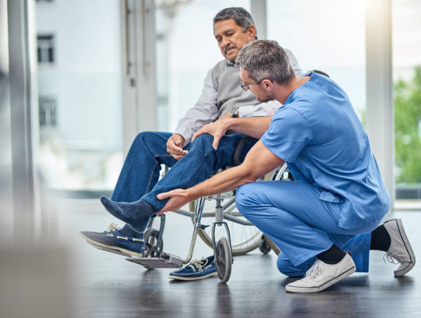 When your joints just aren't what they used to be Shot of a nurse helping a senior man in a wheelchair orthopedics photos stock pictures, royalty-free photos & images