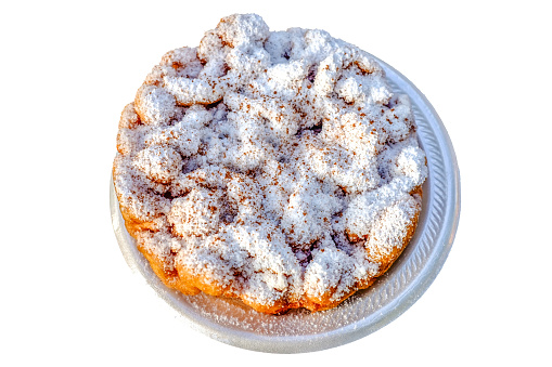 A funnel cake topped with powdered sugar isolated on a white background. Funnel cake is a regional dish popular in the United States at carnivals, fairs, sporting events, and seaside resorts