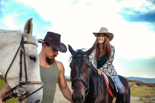 istock Young happy couple enjoying horse ride 1256073443