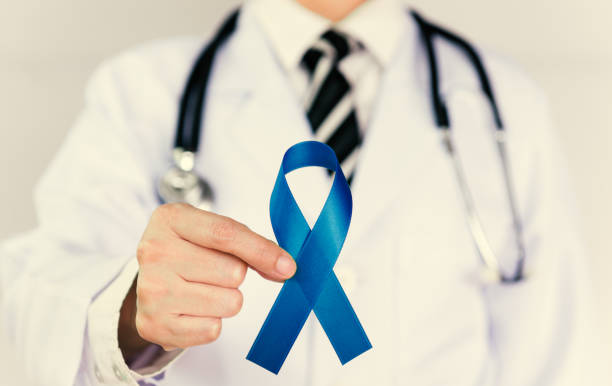 istock Doctor Holds Blue Ribbon 1256075525