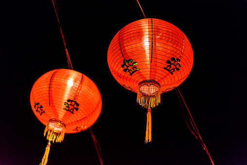 a multitude of red Chinese paper lanterns light up the night on Chinese New Year.