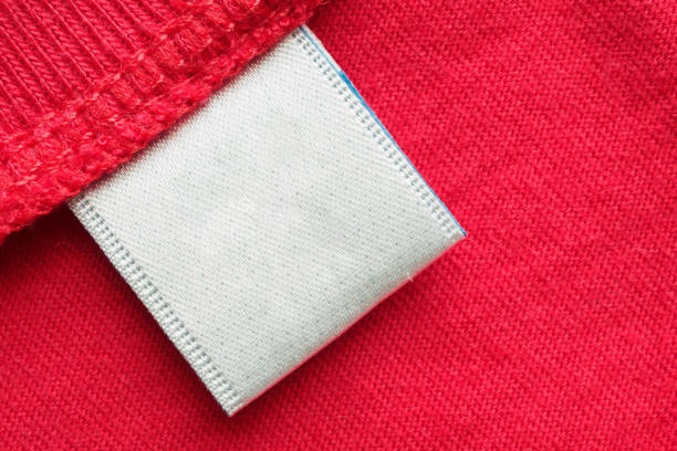 istock White blank laundry care clothes label on red cotton shirt background 1256076342