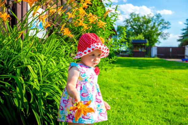 istock Little girl and flower 1256078233