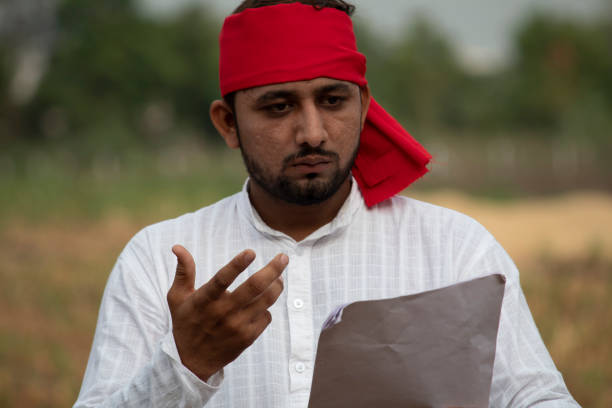 istock Stressed farmer reading contract on agricultural field 1256080224