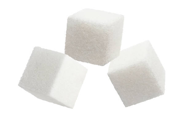 istock Cubes of delicious white sugar on white 1256083501