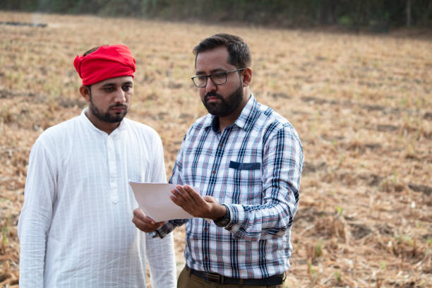istock Salesman explaining contract farming agreement to farmer on field 1256084453
