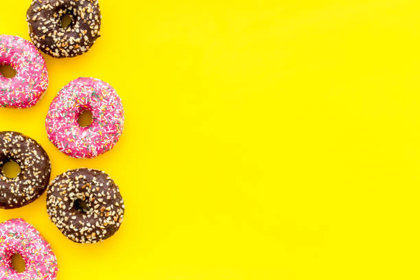 istock Top view of colorful glazed donut swith sprinkles, copy space 1256091253