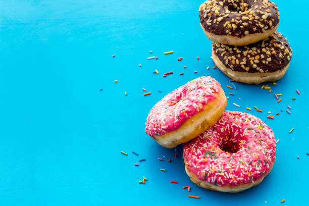 istock Colorful donuts close up, glazed and sprinkles bakery 1256094159