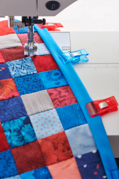istock Making of quilt binding by dint of sewing quilting clips by using sewing machine 1256095485