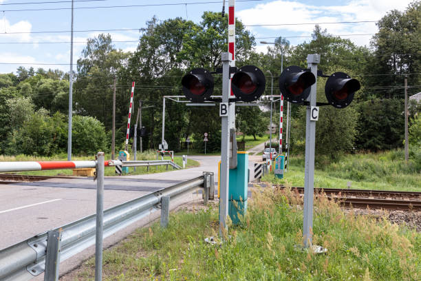 istock Road crossing through the railway tracks. 1256095584
