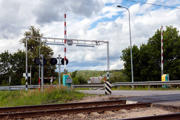 istock Road crossing through the railway tracks. 1256096683