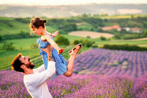 istock Father and daughter have fun in lavender field 1256096970