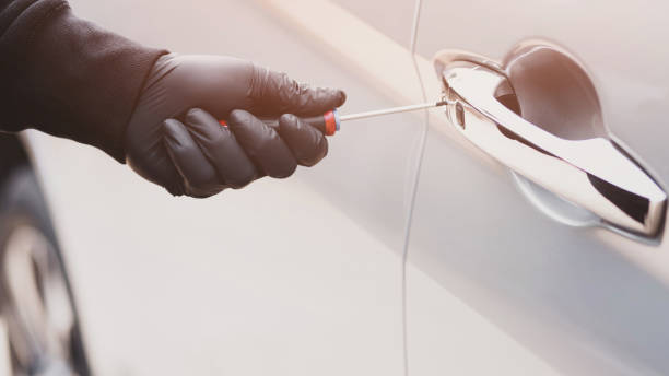 istock The thief is stealing the purse in the car 1256097644