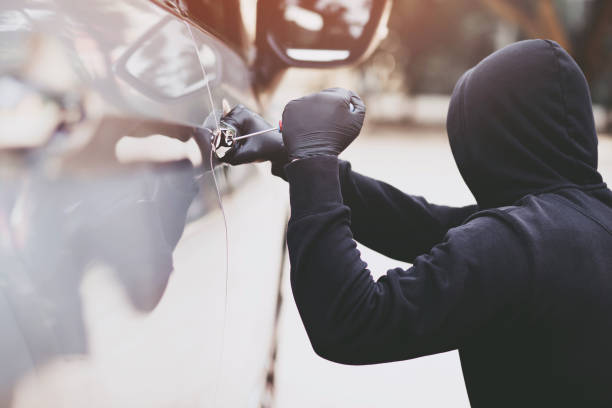 The thief is stealing the purse in the car stock photo