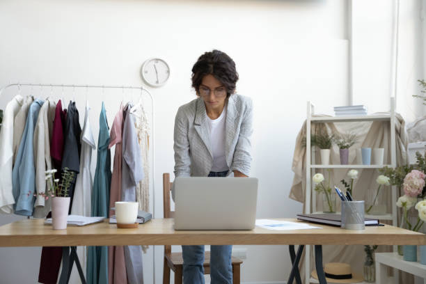 istock Young businesswoman work on laptop consulting client online 1256097765