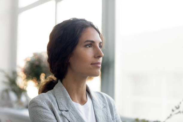 istock Thoughtful young woman look in distance visualizing 1256097803