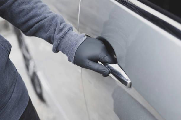istock The thief is stealing the purse in the car 1256097933