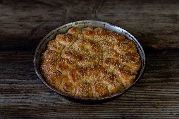 istock Homemade baked bread on rustic wooden background 1256098321