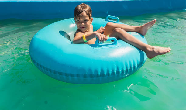 istock Little boy is having fun in the pool 1256099052