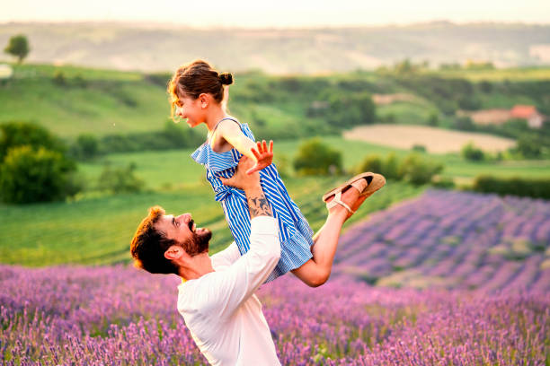 istock Father and daughter have fun in lavender field 1256099202