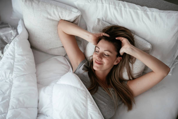 istock Woman stretching in bed after wake up 1256099632