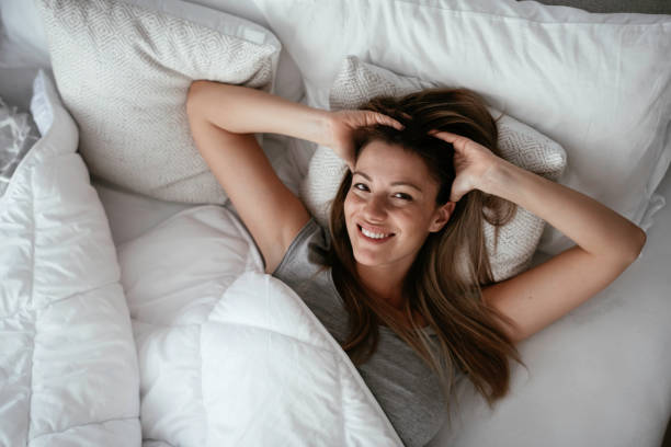 istock Woman stretching in bed after wake up 1256099633