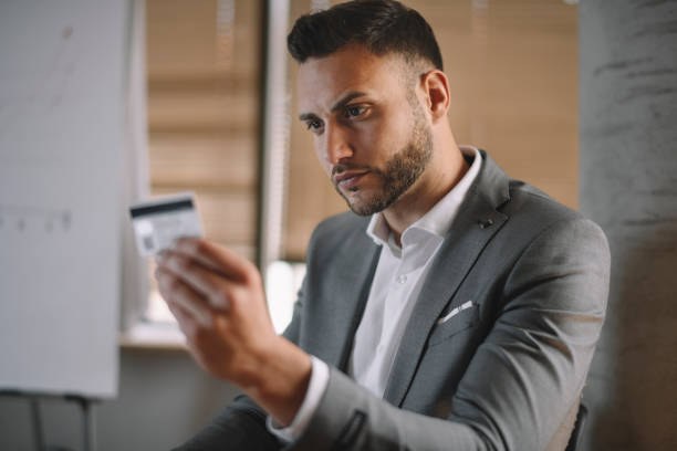 istock Young businessman with credit card. 1256100629