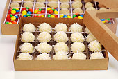 Boxes of Traditional Brazilian chocolate candy called brigadeiro in white chocolate and coconut, walnuts and m&ms  gourmet version