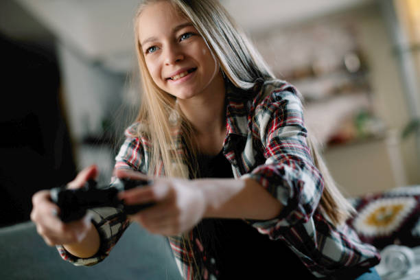 istock Little girl playing video game. 1256102342