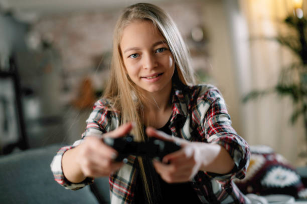 istock Little girl playing video game. 1256102352