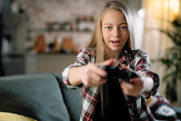 istock Little girl playing video game. 1256102362