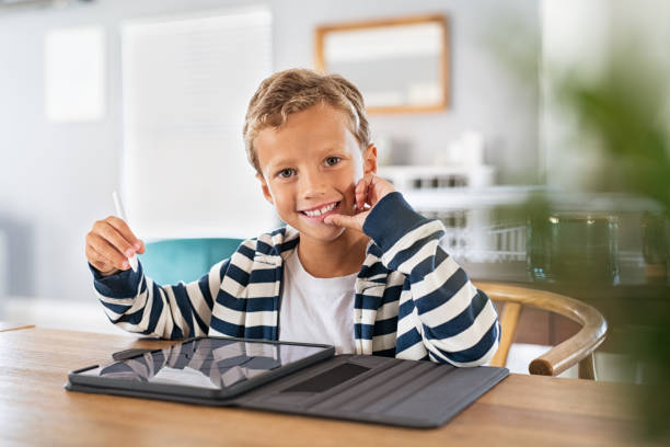 istock Happy smiling child using digital pen and tablet 1256103889