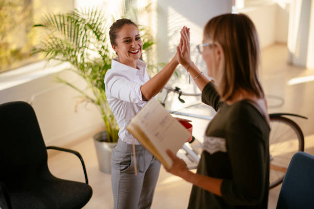 istock Two happy female colleagues discussing work. 1256104218