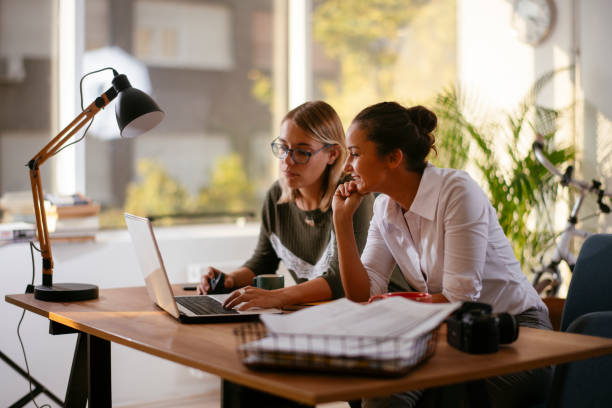 istock Two happy female colleagues discussing work. 1256104268