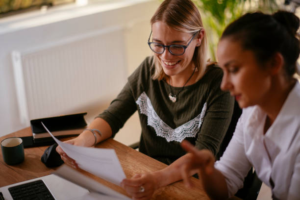 istock Two happy female colleagues discussing work. 1256104347