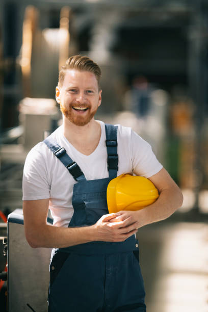 istock Factory worker. Man with helmet working on wires. 1256104622