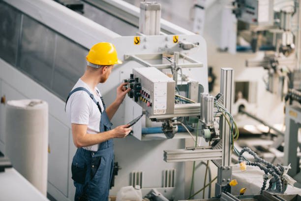 istock Factory worker. Man with helmet working on wires. 1256104632