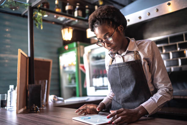 istock Young business owner using a digital tablet at restaurant 1256105549